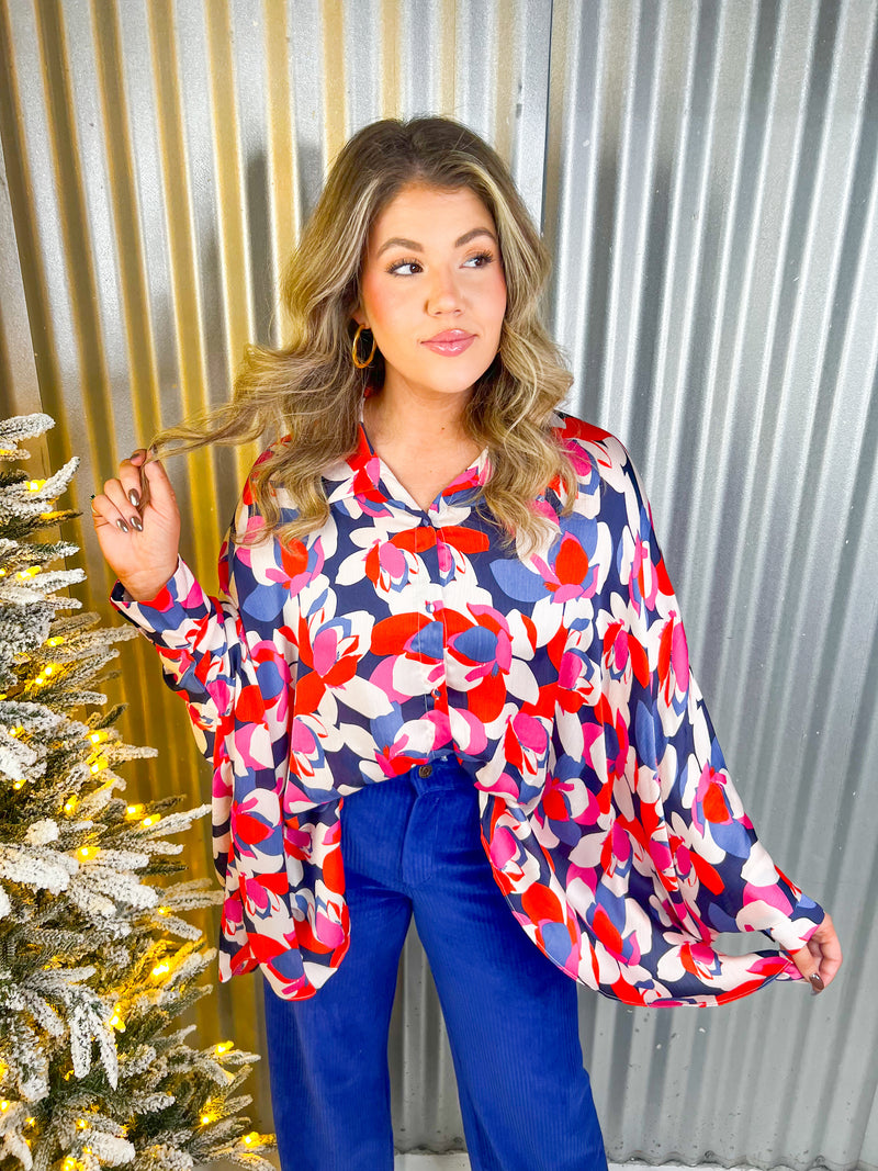 Red, pink, blue, and white floral oversized button down top. 