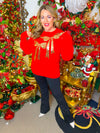 Red Christmas sweater with front gold bow-shaped sequins.