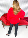 Women’s red turtle neck sweater with bell sleeves. 