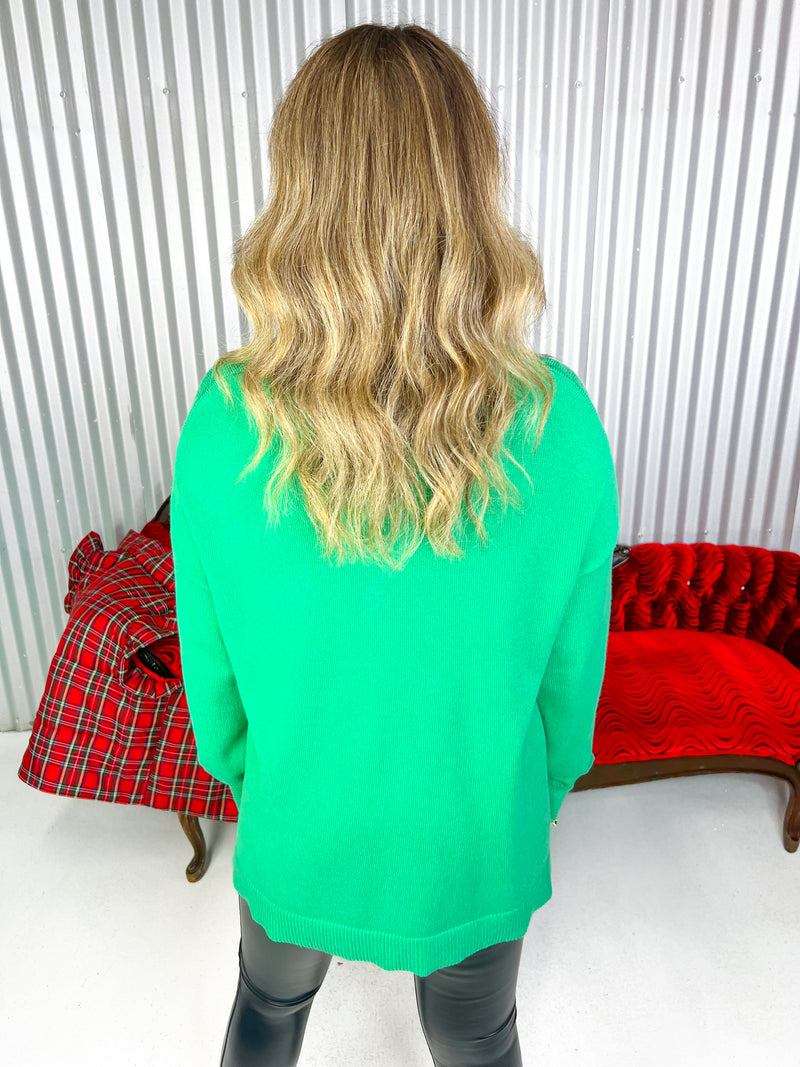 Green v-neck long sleeve sweater. 